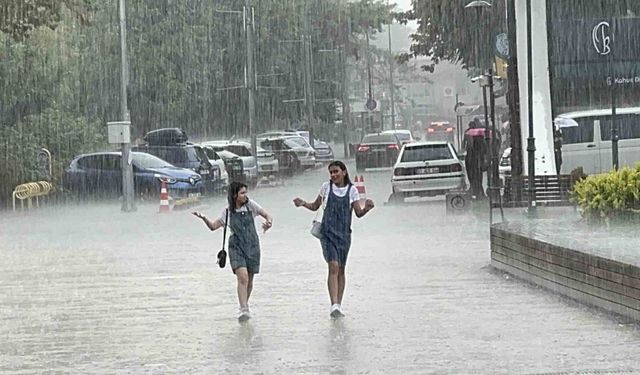 Yağmura sevindiler, yağış altında oynayarak serinlediler